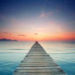 Endless Pier from wooden planks Over the Mediterranean, Glowing Under a Spectacular Summer Sunrise