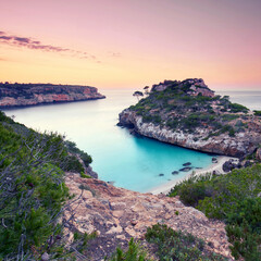 Breathtaking Turquoise Bay Between Cliffs on Mallorca at Sunrise