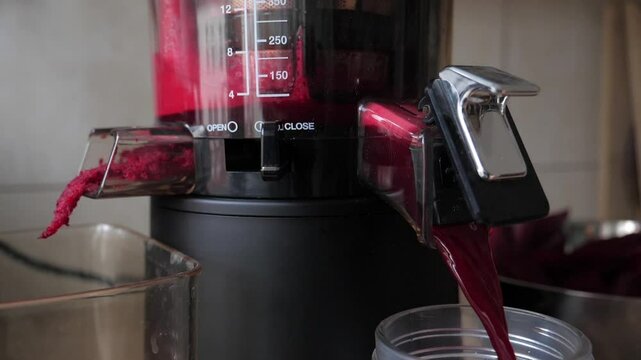 Process of extracting fresh beetroot juice. Slow motion