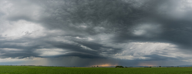 Panoramic scene of severe storm development over Bavaria Germany with menacing dark clouds and...