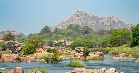 Tungabhadra river with boulders in Hampi, view to Hippie island, landscape South India, Karnataka,...
