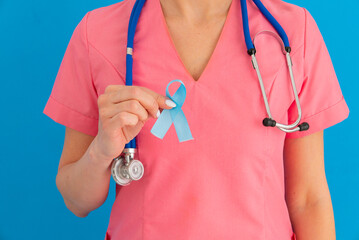 Doctor hands holding blue ribbon, diabetes and Colorectal Cancer Awareness