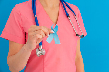 Doctor hands holding blue ribbon, diabetes and Colorectal Cancer Awareness