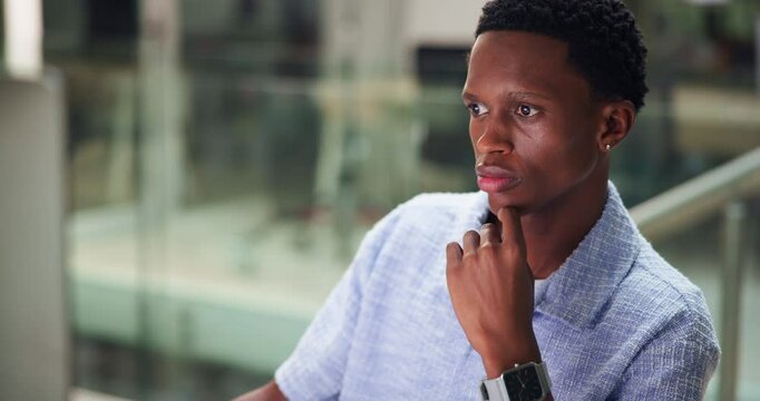 Black man, student or thinking with computer for research, project deadline or design at university. Male person, learner or junior intern on technology in wonder for assignment or internship program