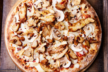 Gyros Pizza with with champignons and mozzarella cheese. Wooden background. Soft focus.	