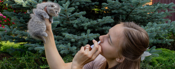 Woman Sneezing from Cat Allergy in Garden