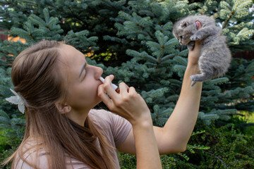 Woman Sneezing from Cat Allergy in Garden