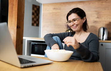 Girl Laughing Watching A Movie On Laptop And Eating Popcorn