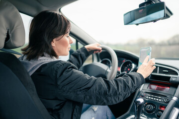 Woman Preparing For A Long Car Trip By Setting The Map Route On Gps Navigator On Smartphone