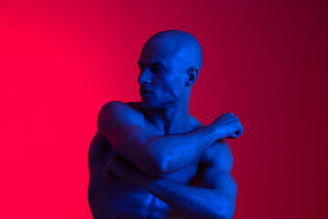 A striking black and white image of a man posing confidently against a vibrant background,...