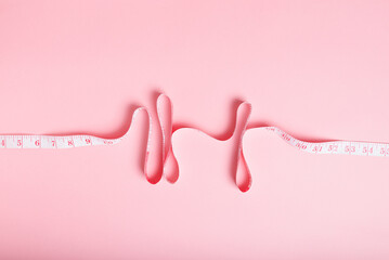 Pink Tape Measure Curves on Pastel Background