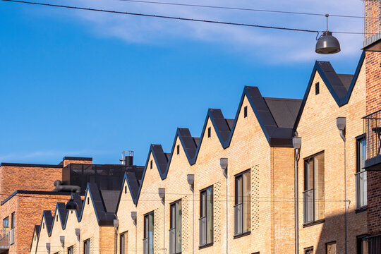 Facade detail of Nordic row houses with sharp gabled roofs and brick texture, &Oslash;restad, Copenhagen, for copy space and architectural planning visuals