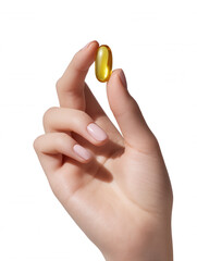 A woman holds a clear yellow capsule between her fingers against a clean white background, showcasing the simplicity and health benefits of the supplement.