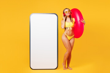 Full body young woman wear bikini rest near hotel pool big huge blank screen area mobile cell phone...