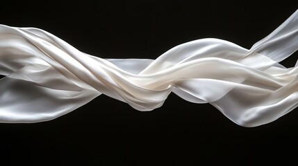 Elegant flowing white silk ribbons gracefully creating ethereal motion against a dark backdrop.