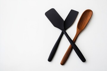 Black and wood dough tools neatly arranged on white surface