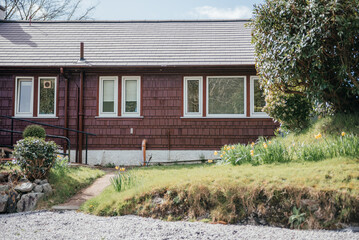 House Front with Windows and Daffodils in Bloom