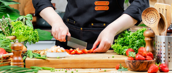 Healthy cooking in a modern kitchen with fresh vegetables and chef preparing vegan food