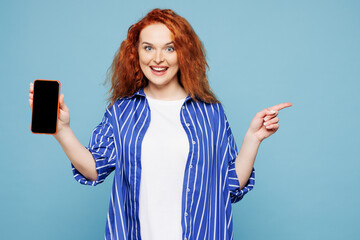 Young ginger woman she wear shirt t-shirt casual clothes hold in hand use mobile cell phone with...