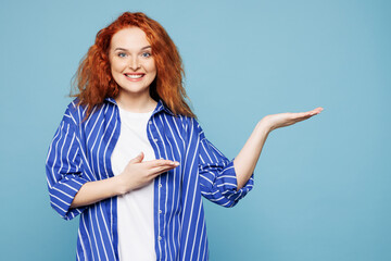 Young happy ginger woman she wear shirt t-shirt casual clothes point hands arms aside on area...