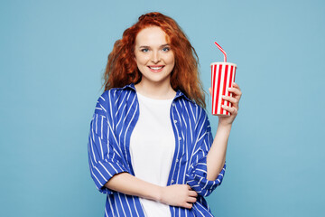 Young ginger woman wear shirt t-shirt casual clothes hold in hand cup of soda pop cola fizzy water...
