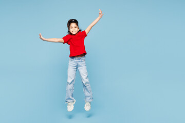 Full body little kid girl 8-9 years old wears red t-shirt have fun jump high spread hands pov fly...