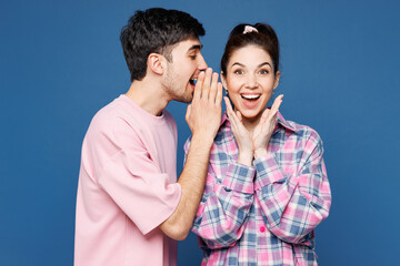 Young couple two friends family man woman they wear pink casual clothes together whispering gossip...
