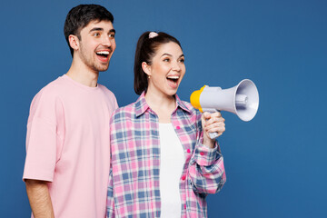 Young couple two friends family man woman in pink casual clothes together scream in megaphone...
