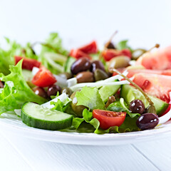 Healthy and tasty salad with , various tomatoes, olives, cucumber, onion and lettuce.	