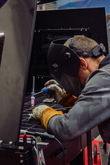 Skilled Welder Carefully Joining Metal Pieces with Precision and Focus in a Workshop Setting
