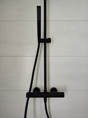 Black Surface-Mounted Shower Faucet on Cream White Tiles