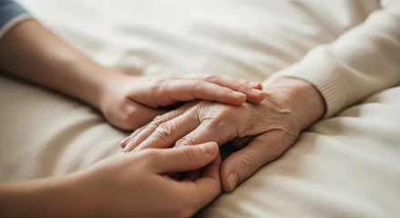 Acrylglasbilder Alte Türen Close up of young hand touching old hand on bed, elderly care, helping elderly people  © Cliff