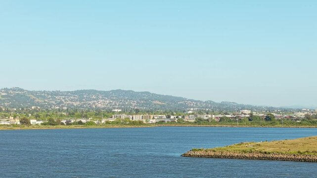 Elevated drone view highlights the peaceful layout of Cesar Chavez Park nestled in Berkeley California beside San Francisco Bay.