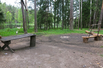 place of rest by a forest lake - a wooden table and a bench