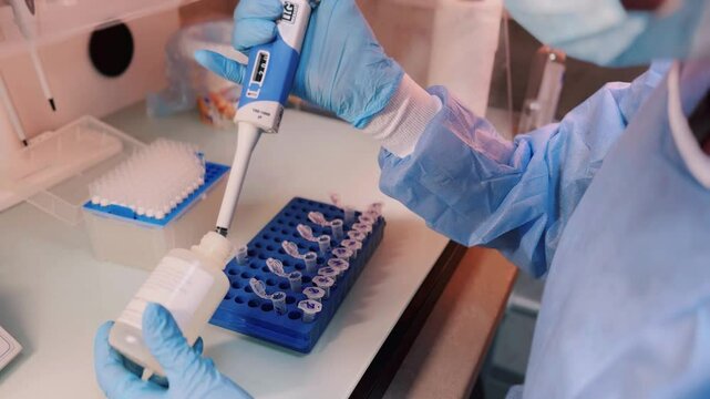 Laboratory technician taking samples of DNA profile fluid - Powered by Adobe