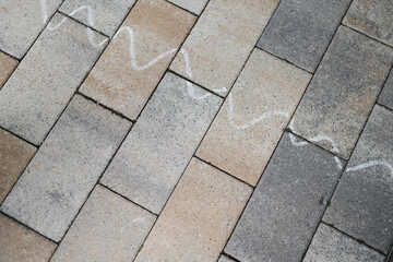 Brickwork with a chalk line drawn on it. Children's art concept on the sidewalk