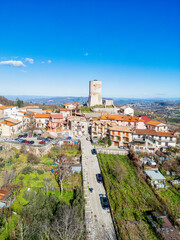 Fototapeta premium Aerial view of Summonte, a charming village in Campania, Italy. The historic tower stands amidst scenic countryside, showcasing the region’s cultural heritage and picturesque landscapes
