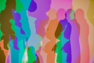 Colorful shadows cast on a wall through RGB lighting
