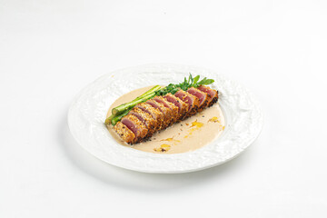 Portion of gourmet grilled tuna with asparagus and sauce
