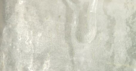 Close-up of the aloe vera leaf pulp. Drops of aloe juice trickle down the gel-like surface. Extract from leaves of aloe vera. Gel serum of aloe vera.