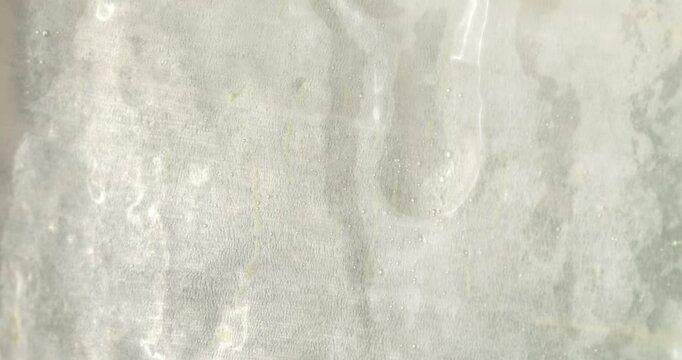 Close-up of the aloe vera leaf pulp. Drops of aloe juice trickle down the gel-like surface. Extract from leaves of aloe vera. Gel serum of aloe vera.