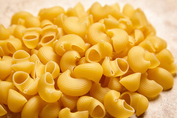 Heap of Pipe Rigate Pasta on Textured Beige Background