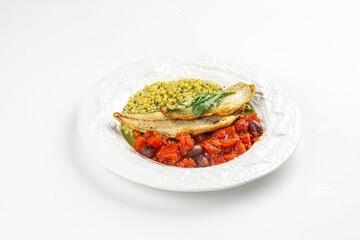 Portion of coooked sea bass fillet with ptitim tomatoes and olives