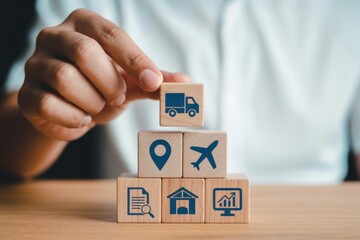 Wooden blocks with logistics icons stacked on a table.