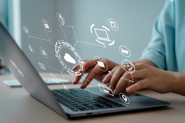 Person working on a laptop with digital interface overlay.