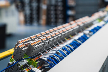 Close up of industrial electrical connectors with blue and orange wires visible
