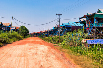 SIEM REAP, CAMBODIA - APRIL 28, 2022: KAMPONG PHLUK FLOATING VILLAGE during the dry season on a hot...
