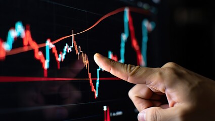 Close-up of hand indicating glowing red and blue lines on a digital stock chart, emphasizing financial data and market movement.