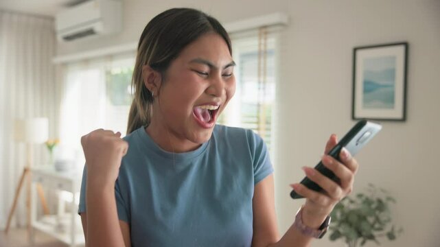 Asia young adult black people humor bizarre funny dance good news at home living room happy joy job hired interview result on mobile, award bonus, win luck bet online game order trade, loan money.