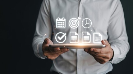 Person holding a tablet displaying project management icons.